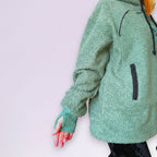 Green fleece hoodie with black accents on a white background