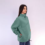 Woman wearing a green sweater with a white background