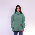 Person wearing a green sweater with a brown patch on a white background