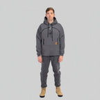 Person wearing a gray hoodie and pants with a white background