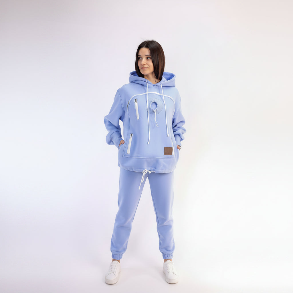 Woman wearing a light blue hoodie and pants on a white background