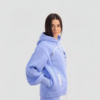 Person wearing a light blue hoodie with a white background