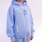 Light blue hoodie with white drawstrings on a light gray background
