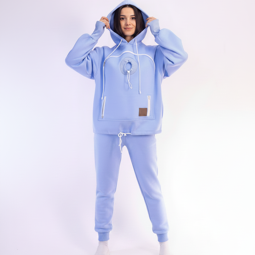 Person wearing a light blue tracksuit on a white background