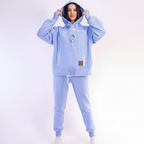 Person wearing a light blue tracksuit on a white background