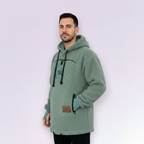 Man wearing a light green hoodie against a white background