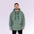 Man wearing a light green fleece hoodie with a logo on a white background