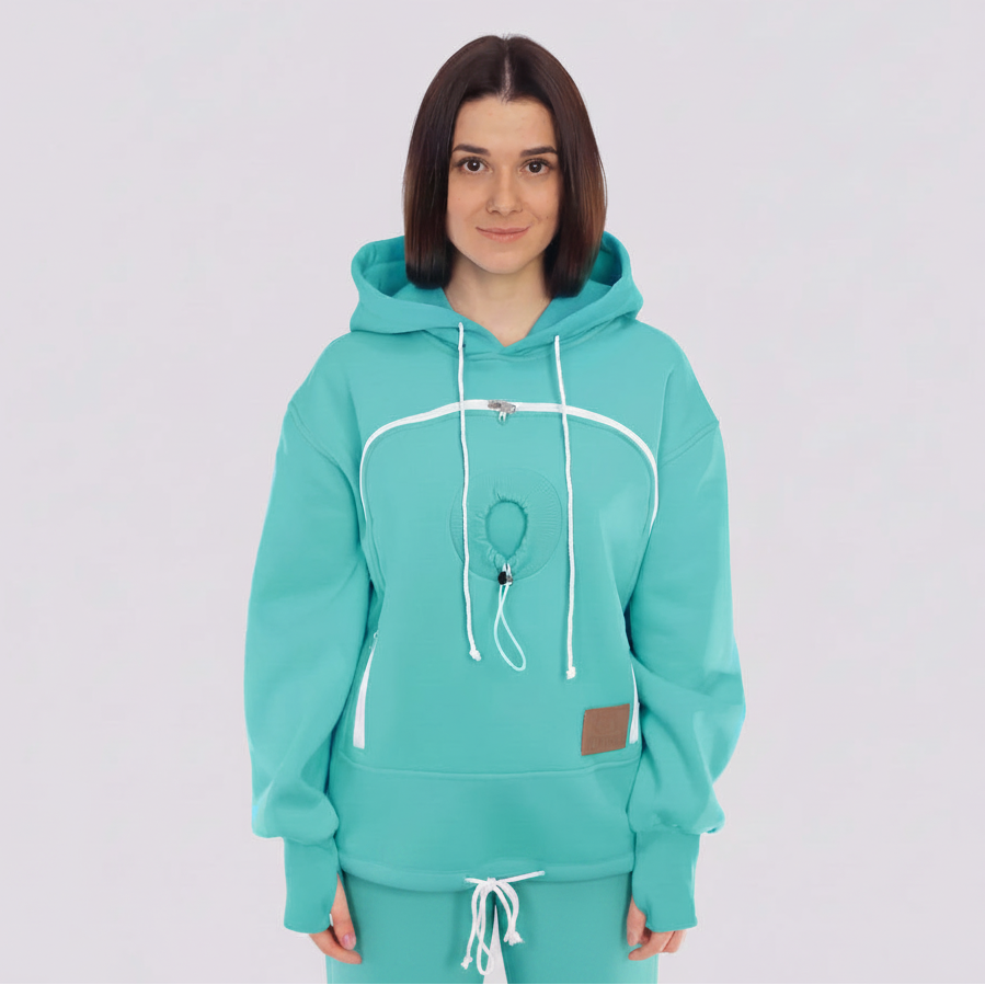 Person wearing a mint hoodie and pants on a light gray background