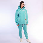 Person wearing a mint tracksuit on a white background