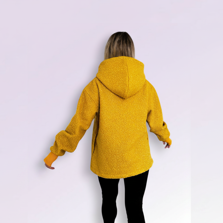 Person wearing a orange hooded coat on a white background