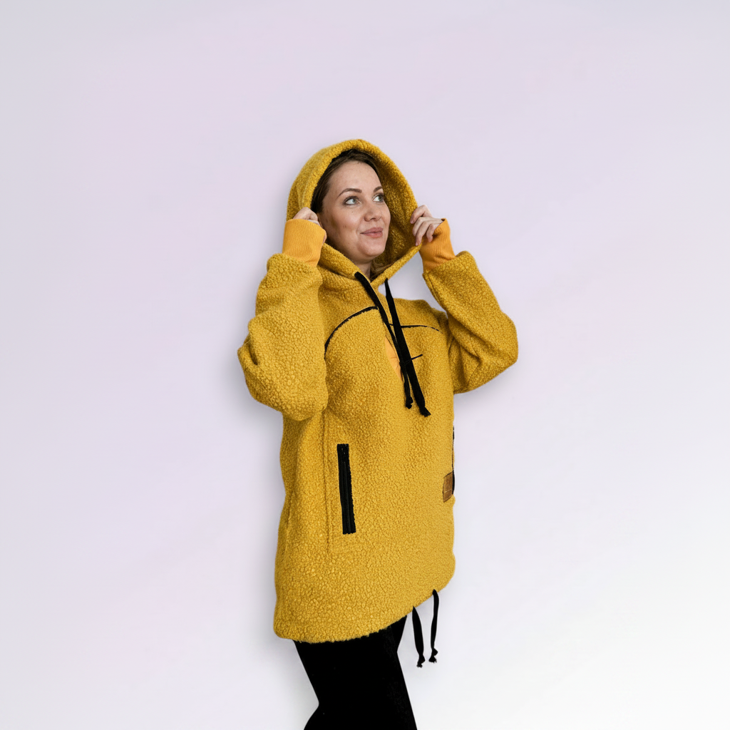 Person wearing a orange hoodie with black accents on a light purple background
