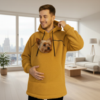 Man wearing a orange boucle hoodie with a dog face design, standing against a plain background.