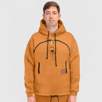 Person wearing a orange hoodie with black accents on a white background