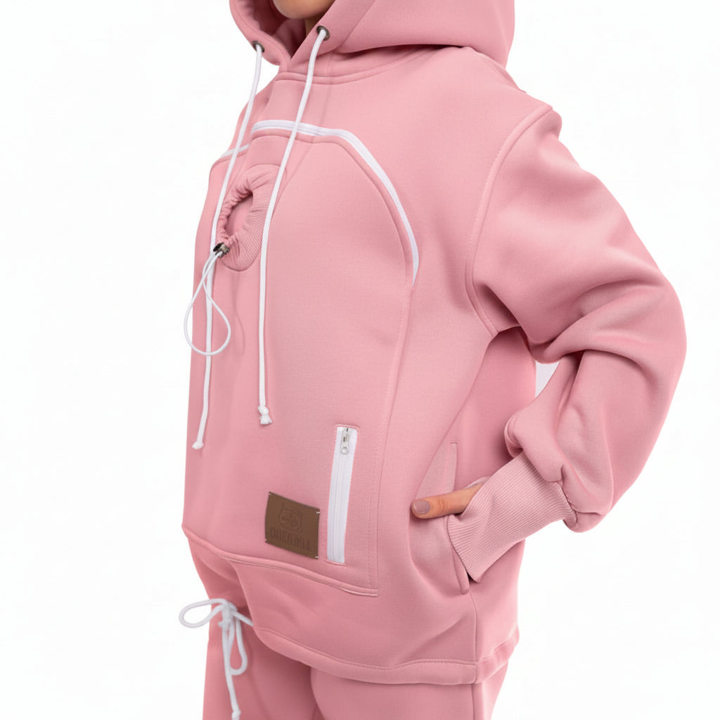 Pink hoodie with a brown patch and white zipper on a light gray background