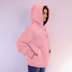 Person wearing a pink hoodie with zippers on a light purple background