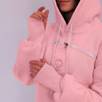 Close-up of a pink hoodie with a zipper on a plain background