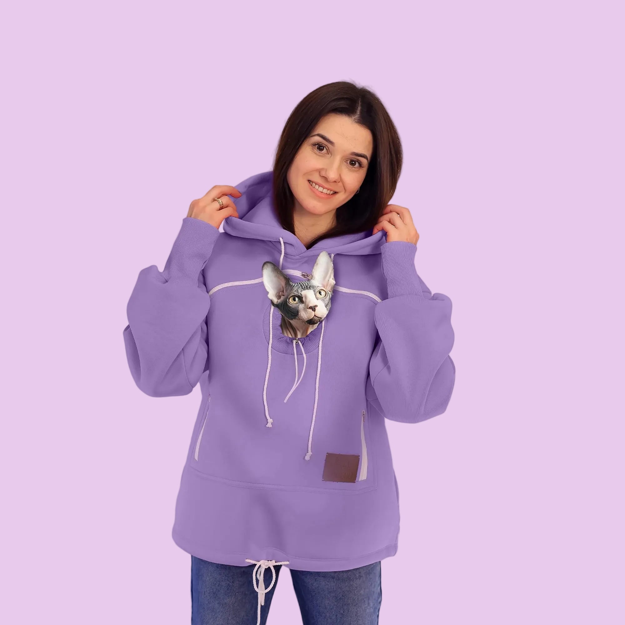 Person wearing a purple hoodie with a small dog on a white background Main image