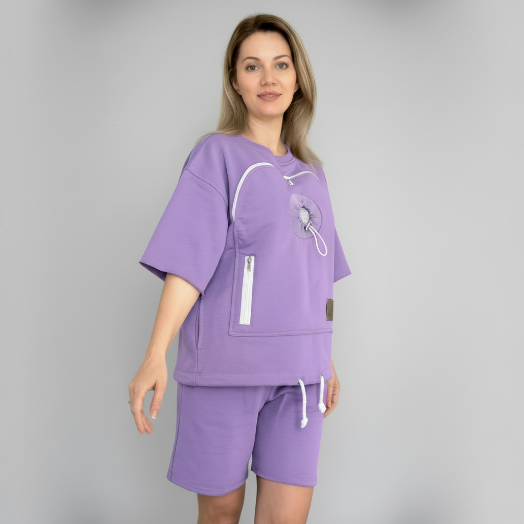Woman wearing a purple outfit with a matching top and shorts on a gray background