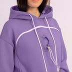 Person wearing a purple hoodie with a plain background