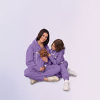Person with children wearing a purple hoodies with a plain background