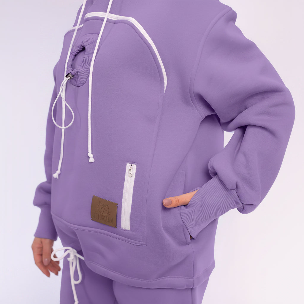 Person wearing a purple hoodie with a plain background
