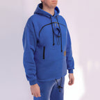 Person wearing a royal blue hoodie with black drawstrings on a white background