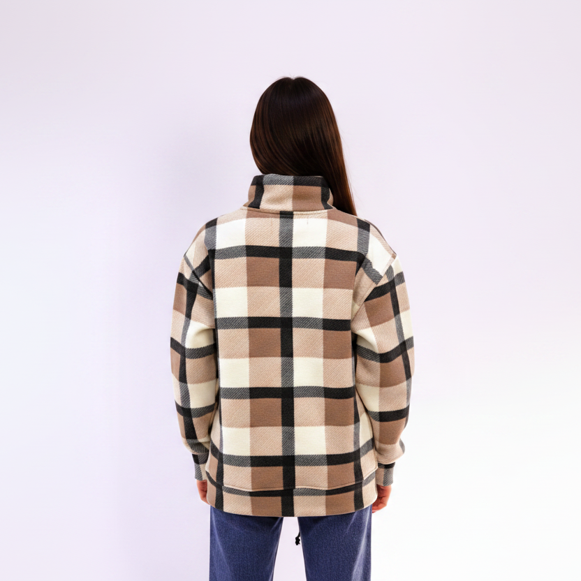 Person wearing a square beige plaid sweatshirt