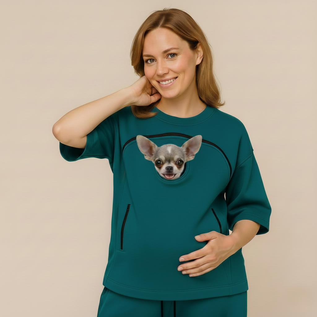 Woman wearing a teal outfit with a dog on a beige background