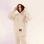 Women wearing a white hoodie and pants on a light background
