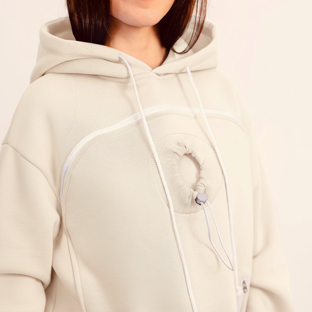 Close-up of a person wearing a white hoodie with white drawstrings.