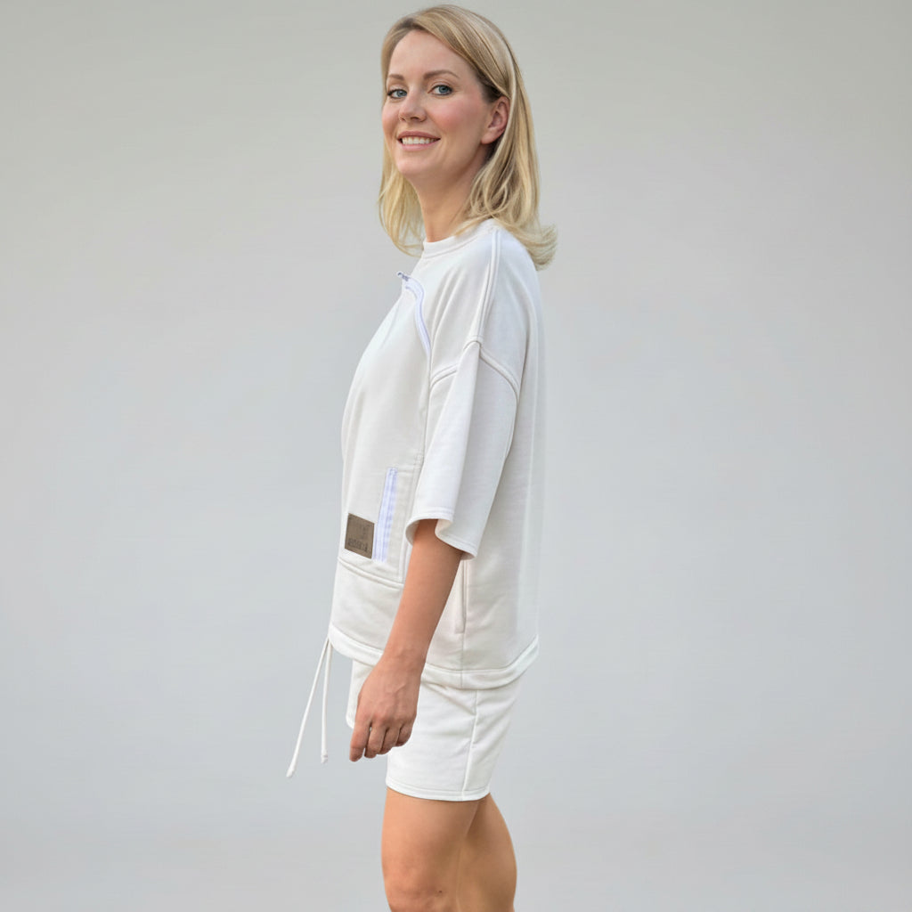 Woman wearing a white outfit with a plain background