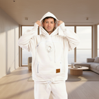 Person wearing a white hoodie with a brown patch on a white background