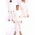 Person wearing a white hoodie and pants with a brown logo patch, standing against a white background.