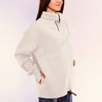 Person wearing a white sweatshirt with a white background