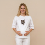 Woman wearing a white t-shirt with a cat on a beige background