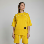 Person wearing a yellow outfit with a plain background