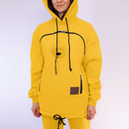 Person wearing a yellow hoodie with black drawstrings on a white background