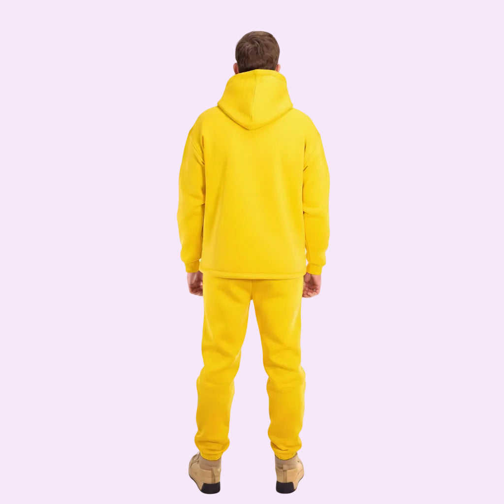 Person wearing a yellow tracksuit on a white background
