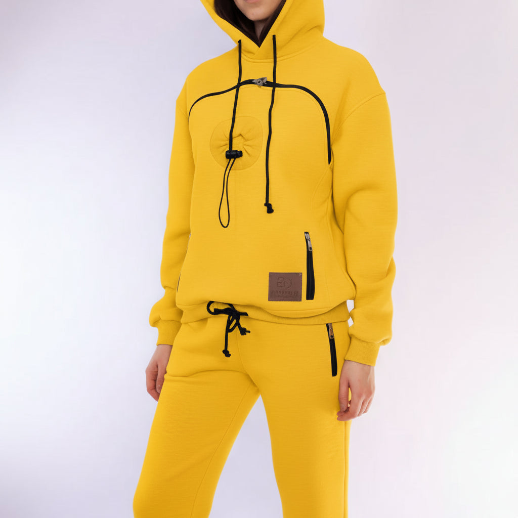 Person wearing a yellow hoodie with black drawstrings on a white background
