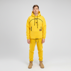 Person wearing a yellow hoodie and pants set on a white background
